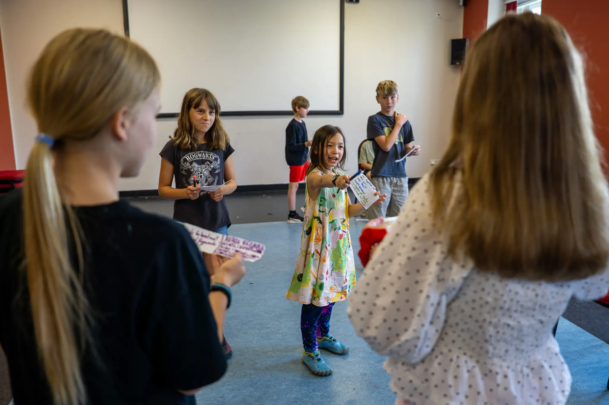 Students holding scripts rehearse a scene during an English-language workshop