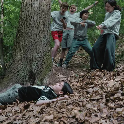 A class laughing through a search-and-reaction game in the forest