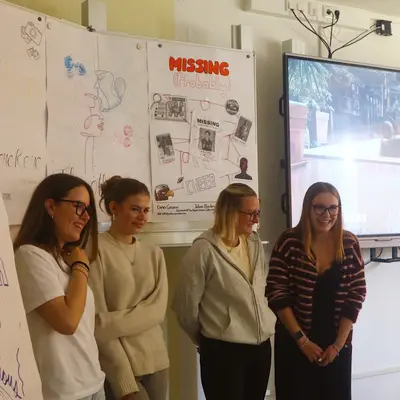 Four students presenting their own storytelling project to the class