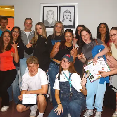 A year group celebrating with certificates at the end of the project week